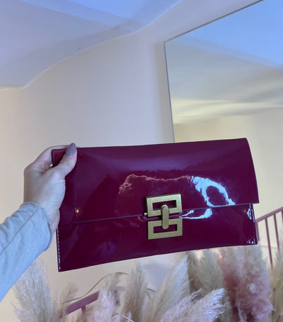 Pochette a mano bordeaux con chiusura in oro